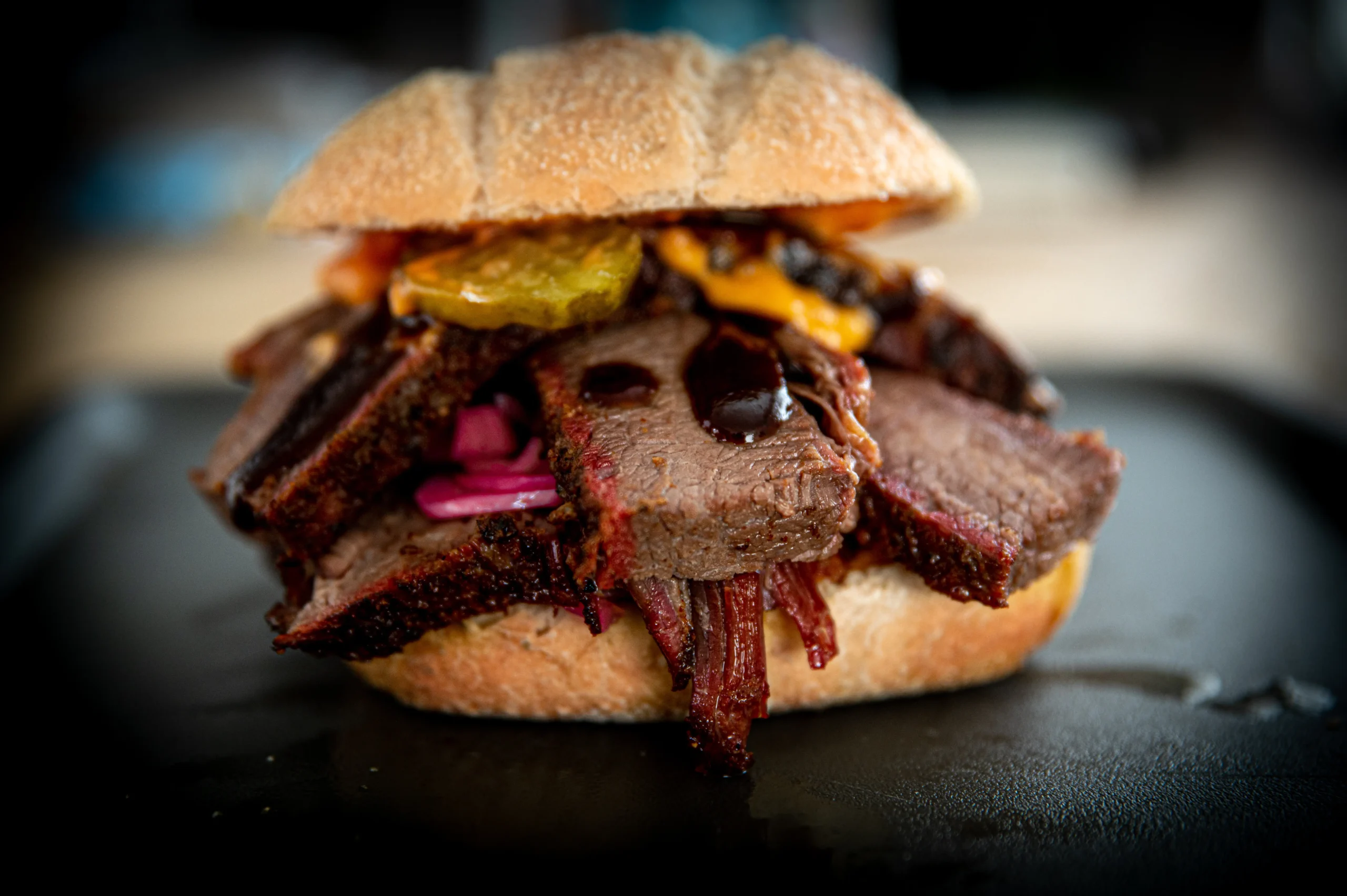 Brisket sandwich met pickles rode ui en BBQ saus